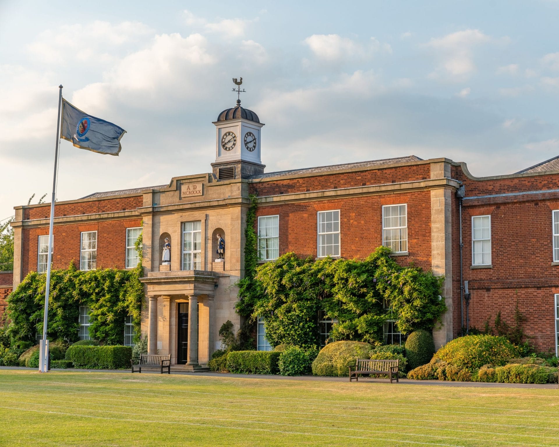 The entrance of the Blue Coat School with a flag waving in the wind in front