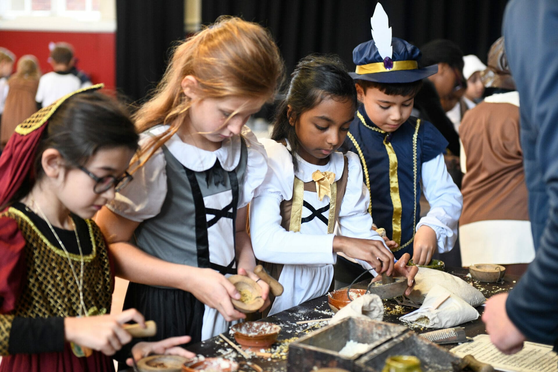 Four pupils practise using tools which were used during Anglo Saxon times during a Humanities enrichment day.