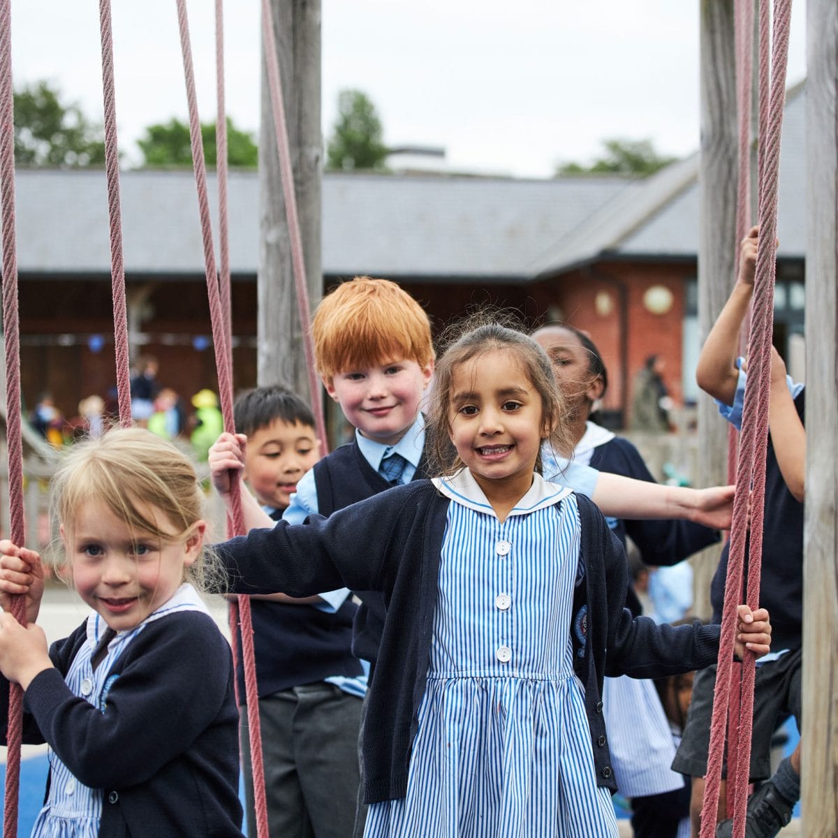 Five Pre-Prep children playing on the adventure trail playground at The Blue Coat School.
