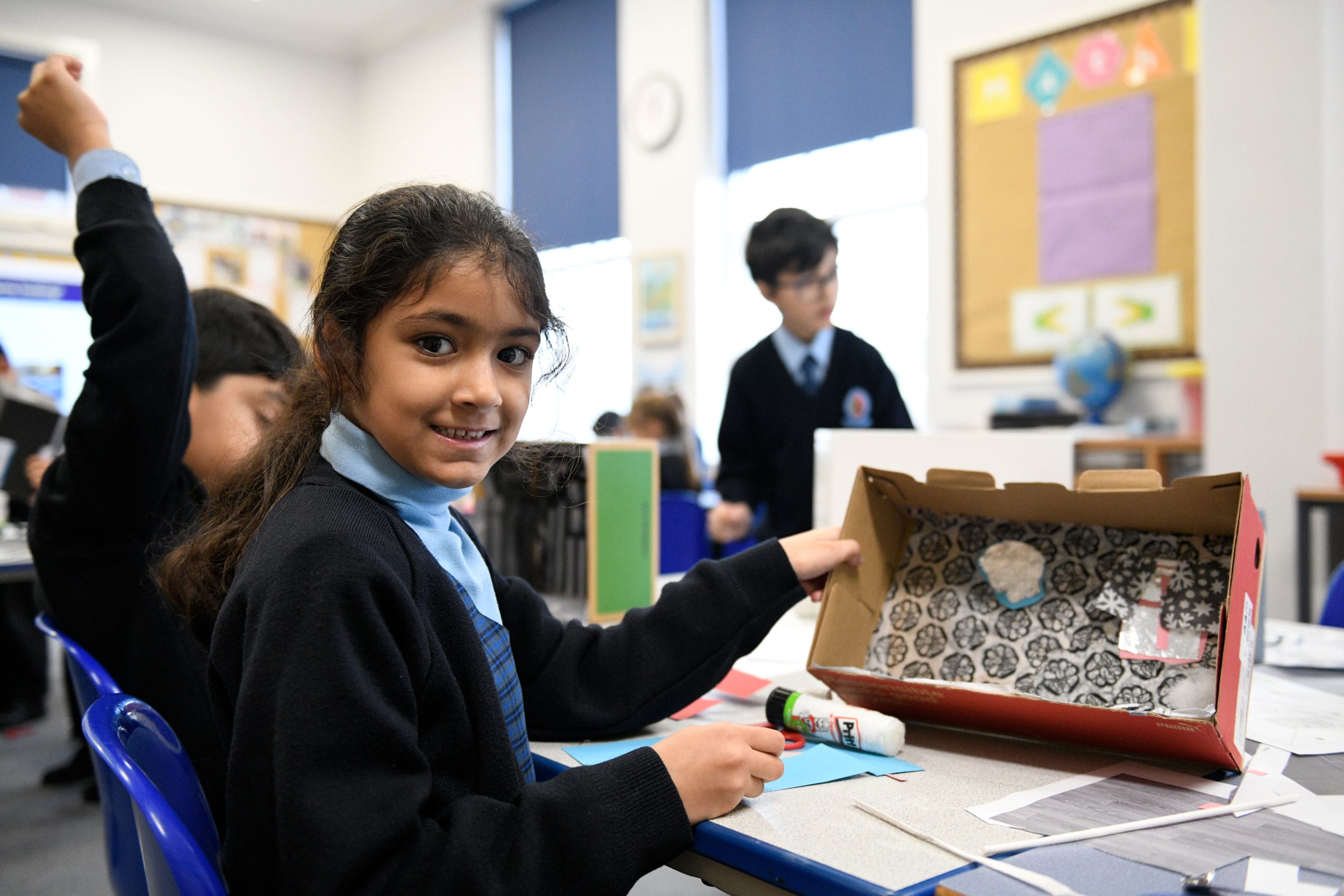 A Year 2 girl in a Science lesson building a diorama.
