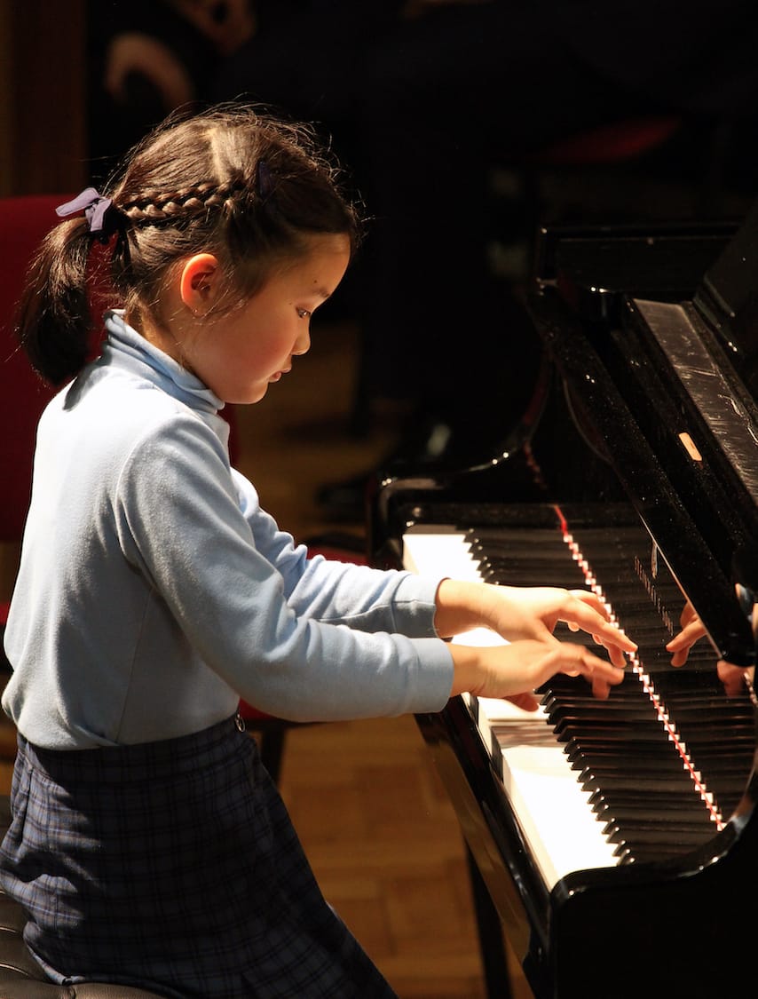 A girl playing the piano.