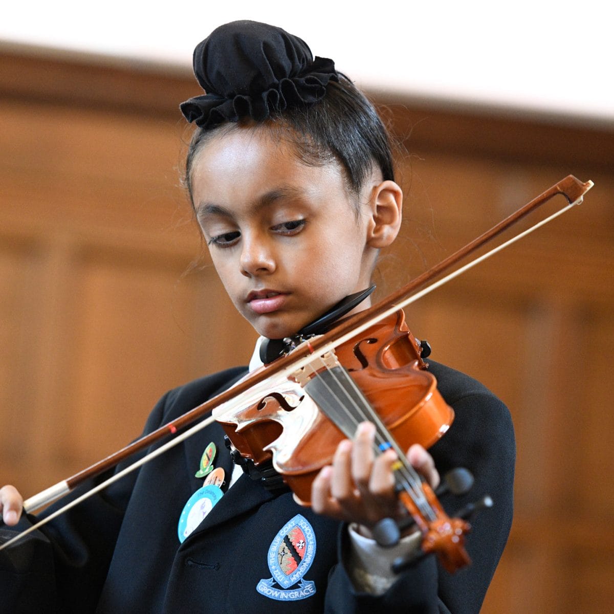 A boy playing the violin in The Blue Coat School Chapel.