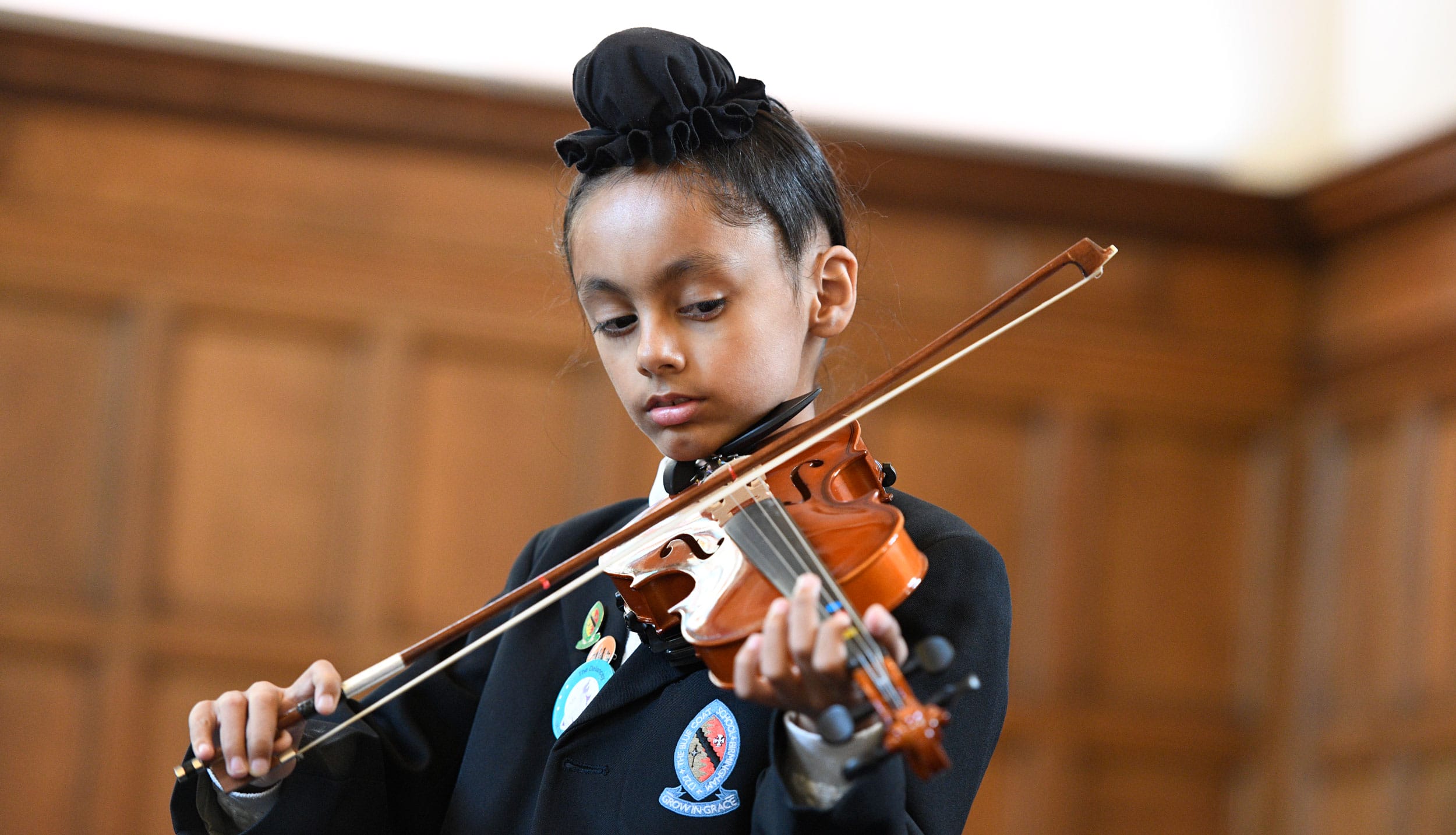 A boy playing the violin in The Blue Coat School Chapel.